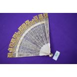 An ivory Brise fan circa 18th century with very fine pierced blades,with carved tips and gilt