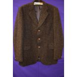 A vintage Harris tweed jacket in brown tones around late 60s/70s, pocket to sides and one to
