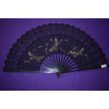 A black gauze and lace fan, circa 1890, with painted butterflies and trimmed with sequins having