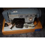 A vintage brother sewing machine and case serial number M768432.