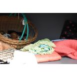 A basket full of vintage and antique items including costume jewellery, handkerchiefs and case,
