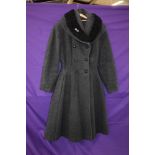 A ladies early 1950s fit and flare coat in grey wool with astrakhan collar,faux double breasted