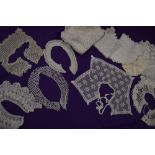 An assortment of early 20th century tray cloths and intricate collars, some crotchet, tatting and