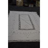 A large antique cut work lace and linen table cloth.