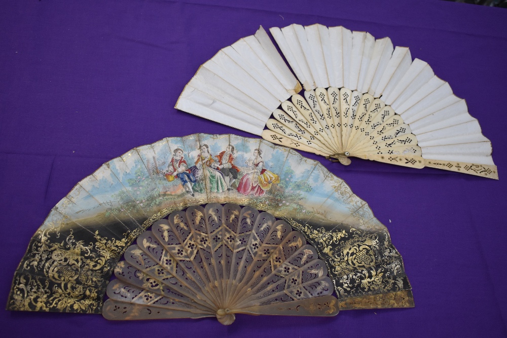 Two lithographic fans, first one having pierced bone ribs and scene of women and rural scenery, - Image 2 of 2