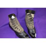 A pair of Edwardian black leather and grey suede boots having mother of pearl buttons to sides and