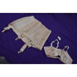 A pale pink CC41 girdle and bra,bra still having original price attached,smaller sizes.