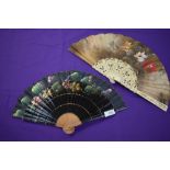 Two hand painted fans having floral scenes to fabric, one having lacquered ribs and the other