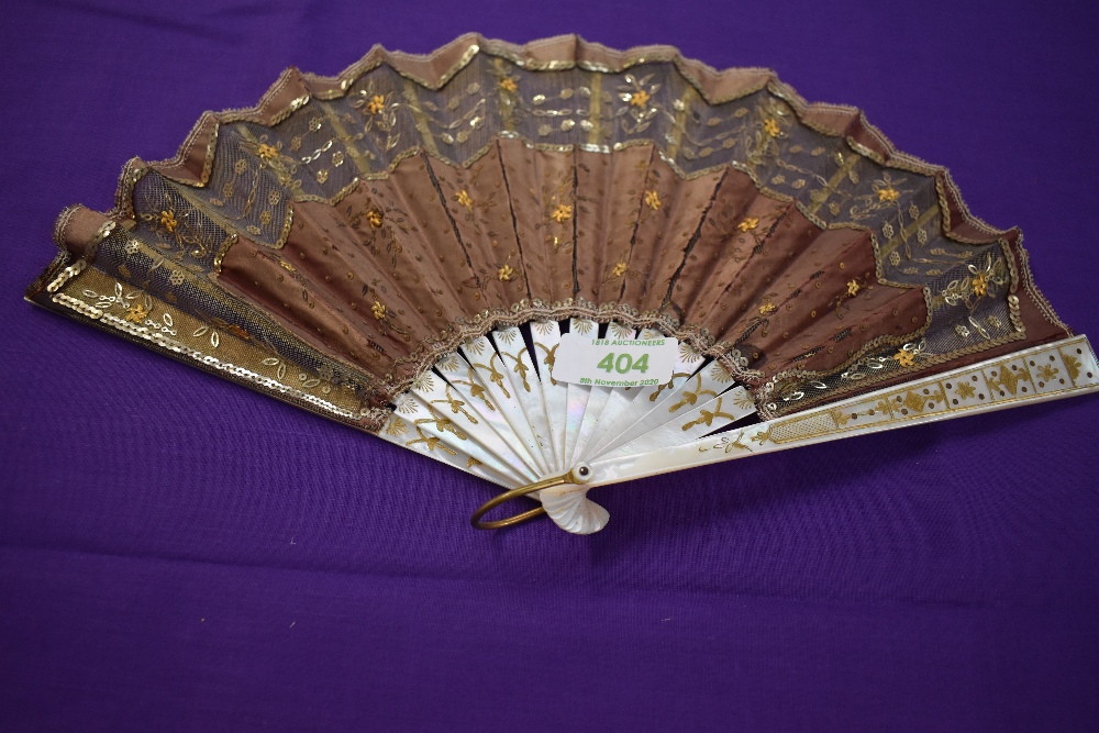 A late 19th early 20th century silk fan having sequins and spangles with mother of pearl ribs with