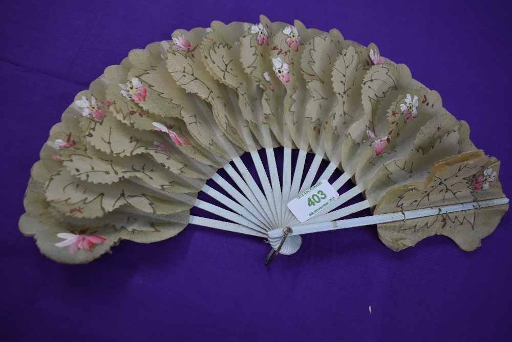 A Victorian fan having hand painted floral paper and gauze like leaves with gilt detailing and