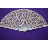 A lace fan, around 1870/80 with mother of pearl ribs with gilt floral detailing.