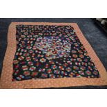 A stunning Victorian patchwork quilt having hexagons to centre surrounded by a border. beautifully