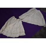 Two late 19th/early 20th century petticoats with cutwork and pin tucks used through both.