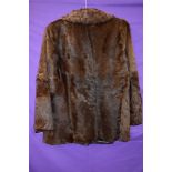 A vintage ladies fur coat, feels to be pony or similar, chestnut brown in colour and fully lined.