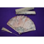 A 19th century Fan in box,having mother of pearl ribs with gilt detailing and silk painted leaf with
