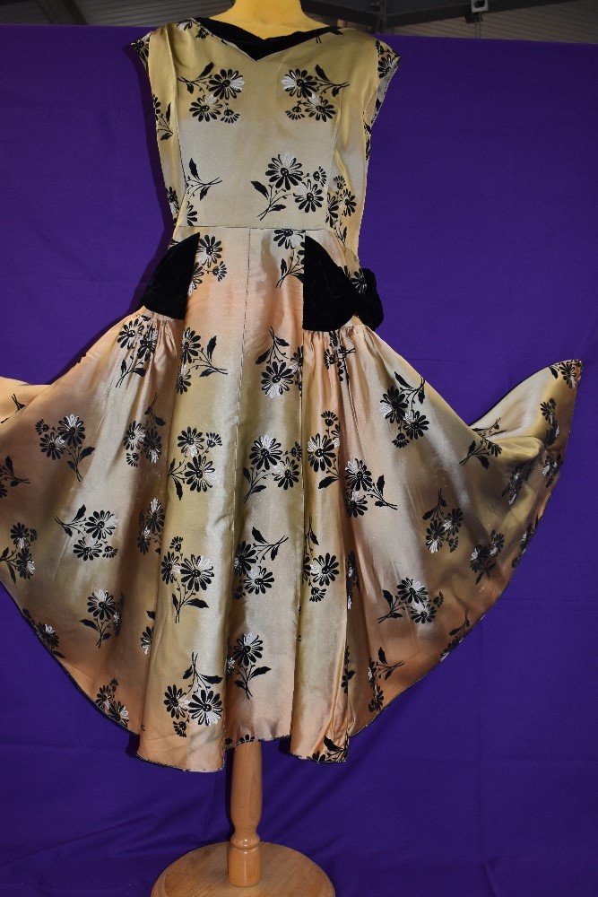 A vintage 1950s gold dress with flocked pattern and black velvet detailing to neckline and skirt, - Image 2 of 4