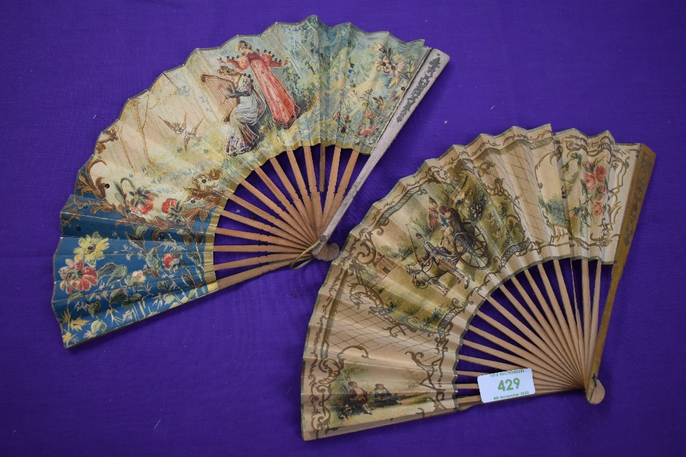 Two paper fans,both having wooden ribs and painted classical scenes, a little wear in places.