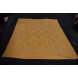 A large vintage bed throw in ochre and white, with busy woven pattern of flowers,Greek key shapes