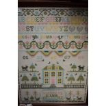 A framed cross stitch sampler worked by E Wier 1992, depicting animals,house,alphabet and more.