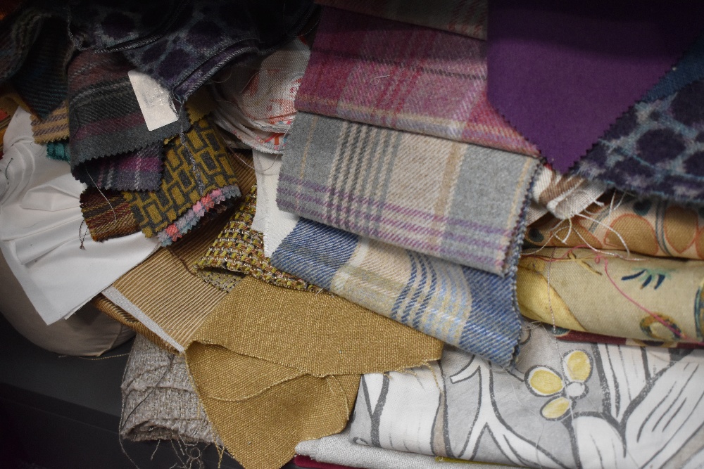 A large quantity of upholstery and lining fabrics, high quality fabrics and names, including tartans