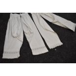 Two pairs of Victorian split leg bloomers with delicate trimming to legs and drawstring fastening to