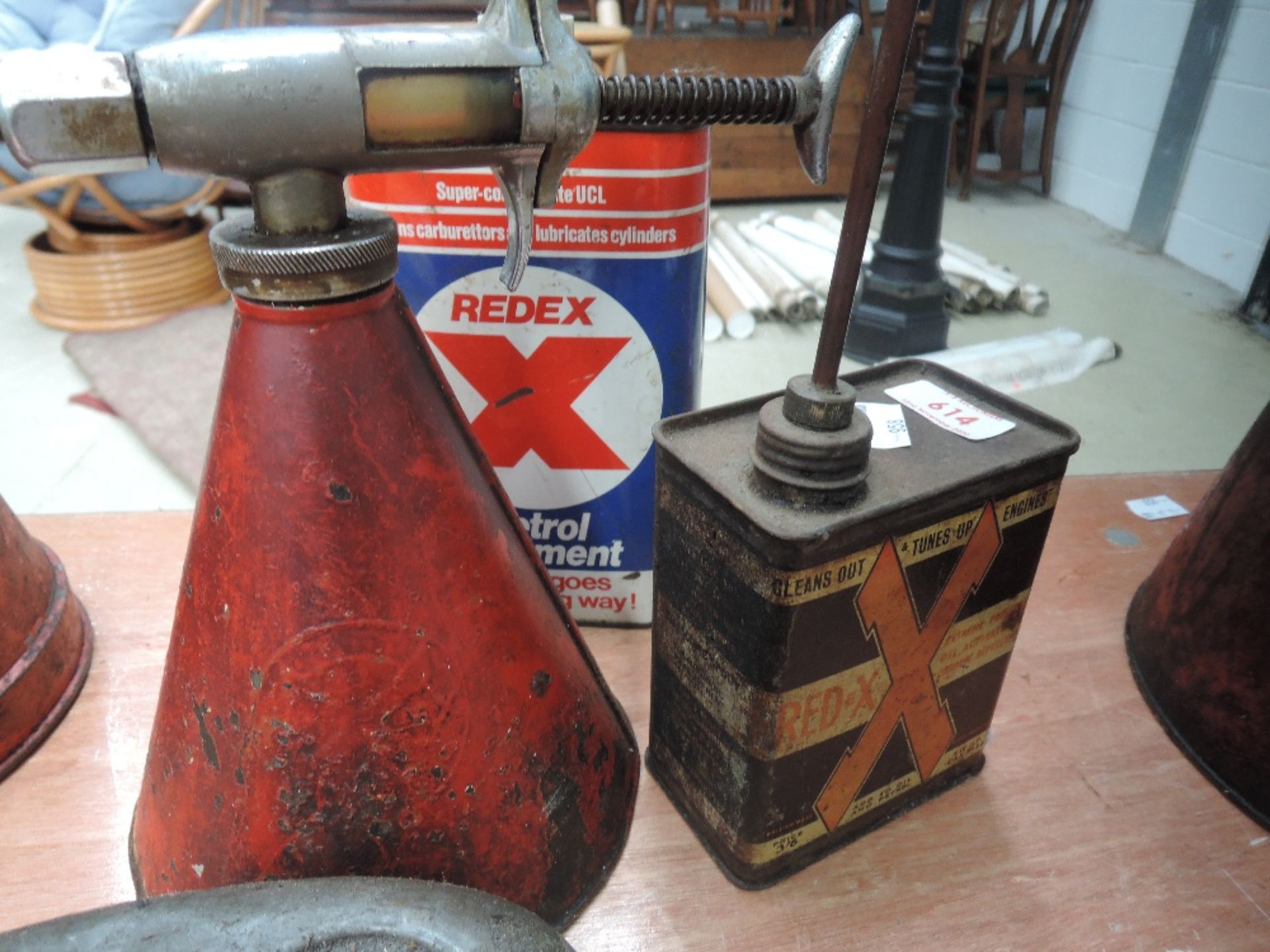 A Redex dispenser and two Redex cans.