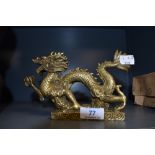 A brass cast Chinese dragon figure measuring approx 20cm long