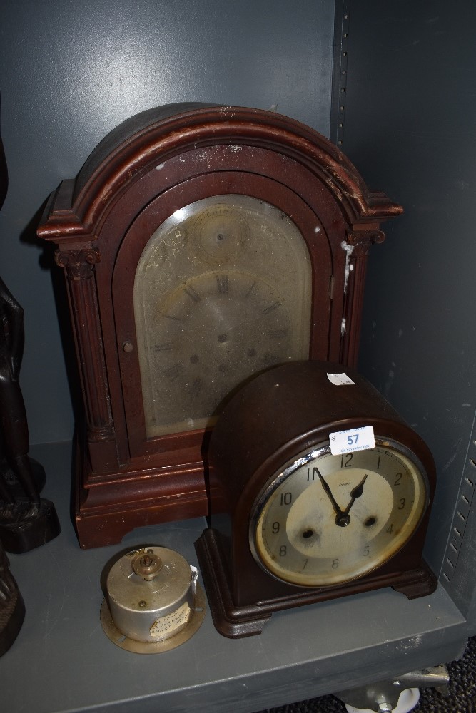 An early plastic Enfield chiming mantel clock and similar wooden cased mantel clock with bevelled