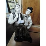 A Laurel and Hardy figurine.