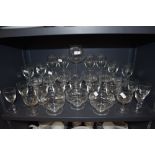 A selection of clear cut and etched glass wares including sundae bowls and wine glasses