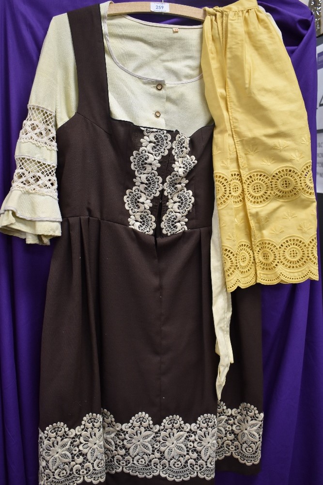 A vintage ladies dirndl dress and blouse and two similar styled aprons,around 1960s.