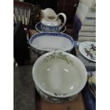 Three pieces of blue and white ware and a chamber pot with green floral pattern and gilt detailing.