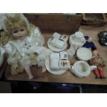 A 1950s childrens tea set with transfer pixie type pattern and three dolls.