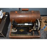 An early hand cranked Singer Sewing machine