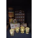 A selection of advertising thimbles and character egg cups