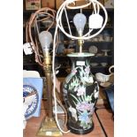 A Victorian Chinese lamp base having black ground decorated with stalks and lillies also heavy