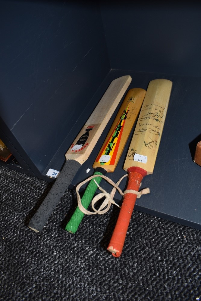 Three miniature cricket bats two bearing signatures one dated 1998 and similar