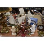 A selection of trinkets including heavy cast horse figure and etched cranberry decanter and glasses