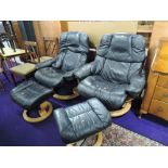 A pair of Stressless armchairs with footstools in dark leather with beech frames