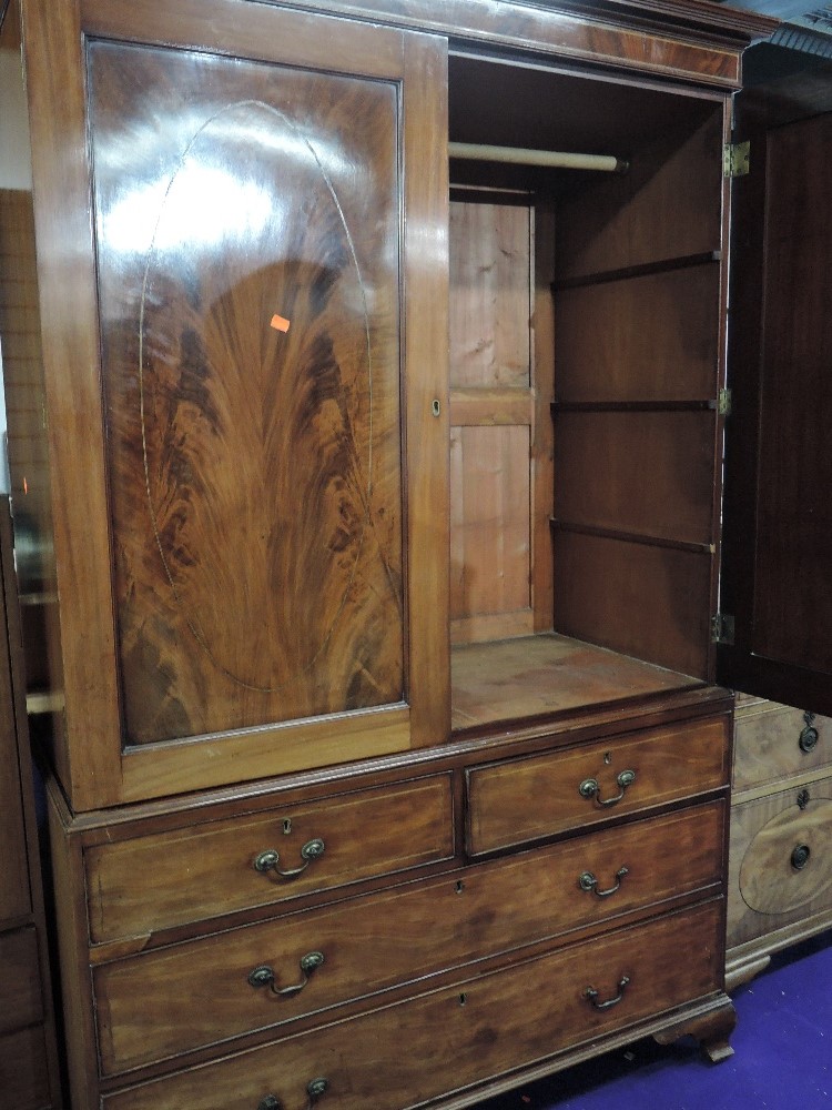 An early 20th Century Regency revival mahogany linen press having two over two drawer base