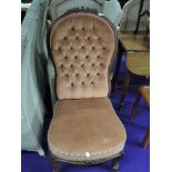 A Victorian button back low seat chair with dralon upholstery on knurl frame