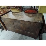 A period oak panelled coffer/kist having carved panel decoration, bearing date 1712, drawer base