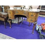 An early to mid 20th reproduction walnut dressing table, of kidney shape