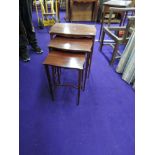 An early 20th Century mahogany nest of three tables, having square tapered legs on spade feet, a few