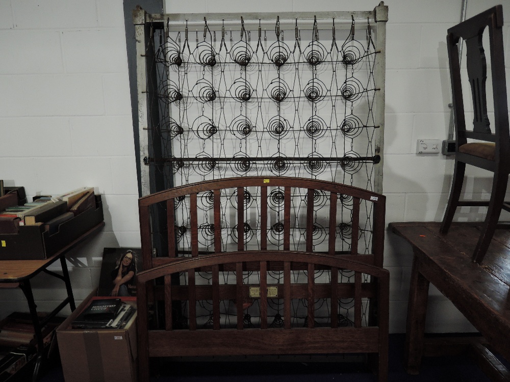 An early 20th Century oak bed, labelled Staples & Co, width 120cm