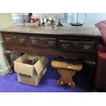 A period oak dresser base, having triple frieze drawers over apron skirting, on cabriole legs, width