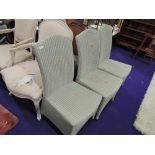 A set four modern Lloyd Loom style dining or conservatory chairs