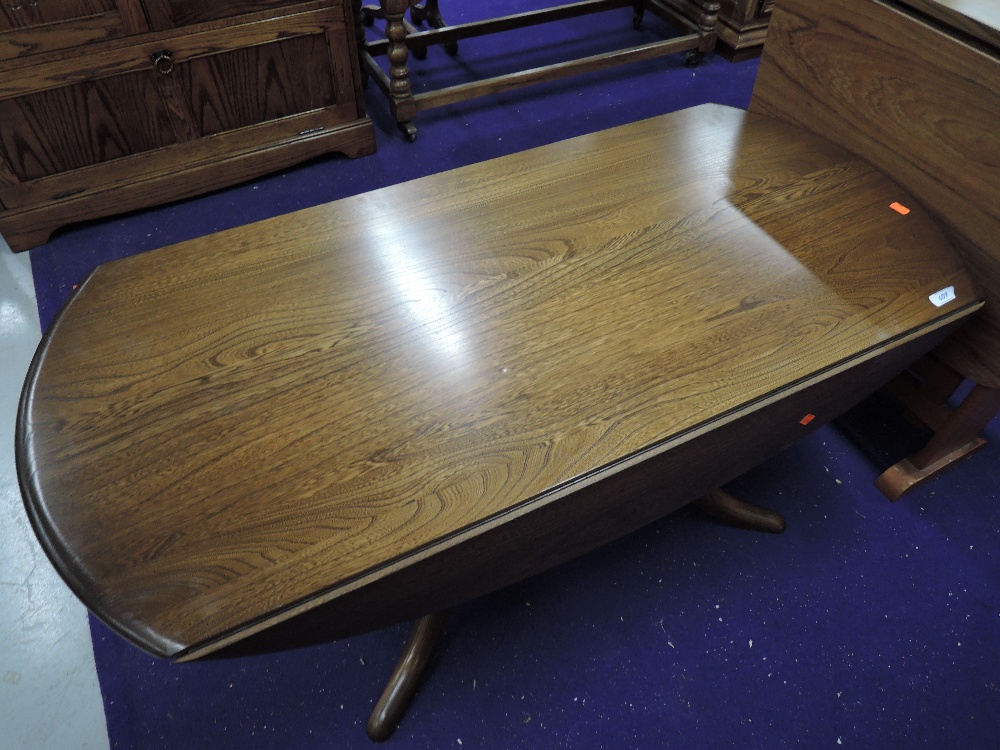 An Ercol mid stained drop leaf coffee table, width approx. 121cm