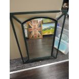 A metal framed arched mirror