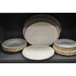 An assortment of Wedgewood plates, graded platters and bowls having basket weave type raised pattern